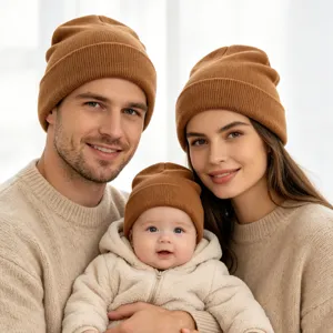 Detailed view of cozy matching brown knitted beanies worn by a happy family in winter.