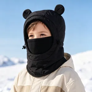 Close-up detail of children warm winter bear ear fleece balaclava hood in snow scene.
