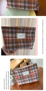Detailed view of the stylish autumn and winter plaid woolen cosmetic bag, showing fabric texture.