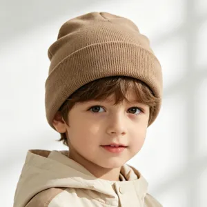 Children knitted beanie hat in camel color, soft warm winter cap for kids daily wear detail.