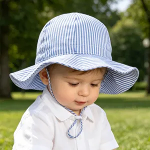 Detail view of the infant summer sun hat featuring blue and white stripes and adjustable strap.