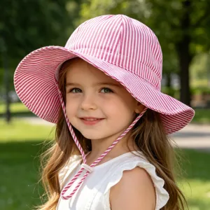 Detail view of pink white striped kids sun hat, wide brim outdoor bucket hat for toddler.