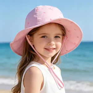 Cute pink children sun hat detail, beach wear style with lovely heart and ribbon prints for kids.