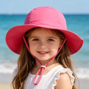 Details of kids pink sun hat with adjustable chin strap for outdoor beach protection.