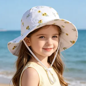 Cute floral bucket hat close-up, children sun protection hat detail view, beach summer wear.