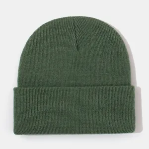 Detailed view of dark green knitted winter beanie, showing fine knit texture and warm cuff.