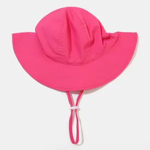 Close-up detail of bright pink kids sun hat with adjustable chin strap for outdoor protection.