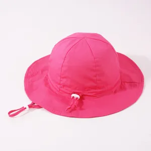 Detail view of pink kids bucket hat with adjustable white drawstring and secure toggle.