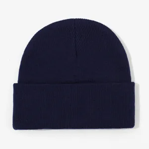 Detailed close-up of a classic navy blue knitted beanie hat showing fine texture.