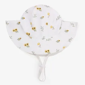 Cute floral baby sun hat detail showing breathable white fabric and adjustable chin strap.