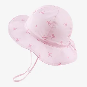 Cute pink baby sun hat with bow print, adjustable chin strap, ideal for kids outdoor wear.