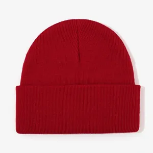 Red knitted beanie hat, warm winter pull-on cap with cuff, classic casual solid color design.