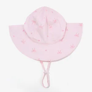 Pink baby sun hat detail showing cute bow print and adjustable chin strap design for kids.