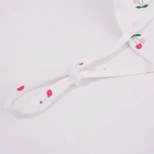 Close-up of children's sun hat windproof strap and white plastic adjustable buckle detail.