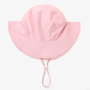 Detail shot of pink kids sun hat with adjustable drawstring and wide brim for outdoor wear.