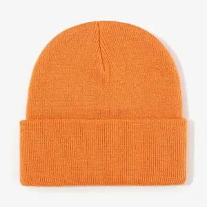 Close-up of bright orange ribbed knit beanie with cuffed brim, winter warm texture detail.