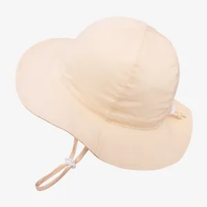 Kids sun hat detail shot, adjustable toggle chin strap, breathable beige fabric material.