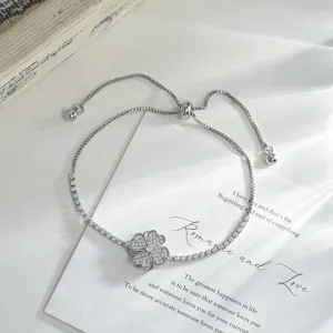 Detailed view of a luxury micro-set zircon four-leaf clover adjustable slider bracelet.
