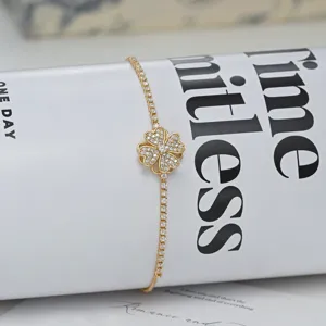 Exquisite gold clover zirconia bracelet with sparkling stones and adjustable chain design.