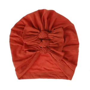 Cute baby turban hat with triple bow knots, soft knitted pleated headwear for infants.