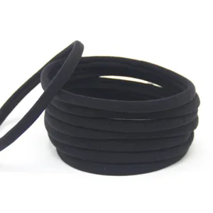 Close-up detail of black seamless elastic hair ties, soft stretchy material for daily styling.