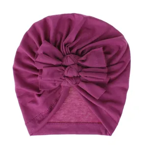 Soft knit baby turban hat with cute layered bow, comfortable everyday accessory.