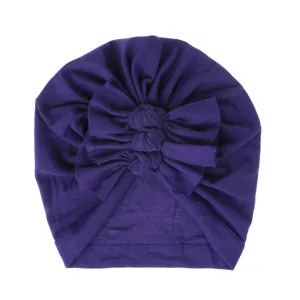 Soft knit baby turban hat with stylish bow knot detail, comfortable purple headwear for infants.