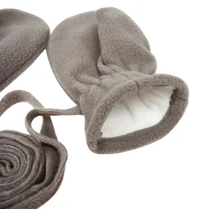 Detailed close-up view of warm fleece baby mittens with anti-lost neck string, winter outdoor.