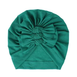 Detailed close-up view of dark green baby turban hat featuring cute triple knot bow design.