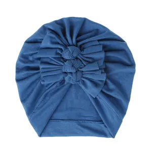 Blue baby turban hat with cute triple bow and soft knitted pleated design for infants.