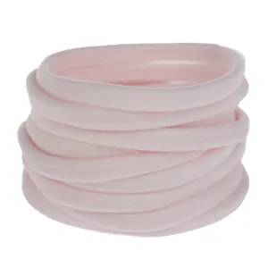 Pink elastic nylon hair bands detail view, soft baby headband DIY material loops.