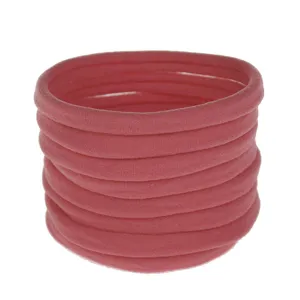 Close-up detail of soft pink elastic nylon hair bands stacked neatly, ideal for DIY accessories.