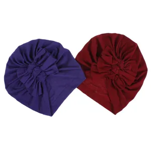 Soft knitted baby turban hat with pleated bow detail, comfortable infant cap for spring and summer.