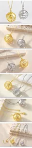 Detail shot of hollow globe pendant necklace in gold and silver finishes, exquisite craftsmanship.