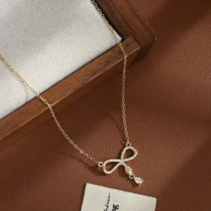Exquisite gold-plated micro-paved zircon bow necklace detail, elegant and versatile accessory.