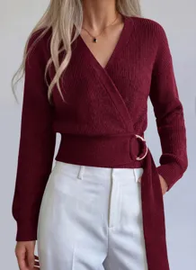 Close-up of women burgundy wrap knit sweater featuring stylish metal ring buckle and V-neck.