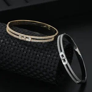 Close-up detail shot of double row paved zirconia and shell lock bangle bracelet.