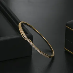 Gold plated micro-pave zircon geometric bangle bracelet, elegant luxury women jewelry detail.