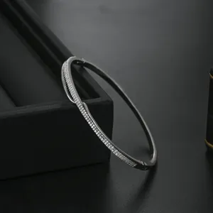 Exquisite micro-paved cubic zirconia bangle in a sleek silver-tone metal finish detail shot.