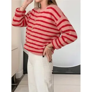 Detail view of the pink and red striped knitted cardigan featuring round neck and button closure.