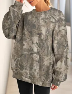 Detailed view of women's tree branch print crewneck loose sweatshirt for casual autumn wear.