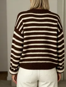 Detail shot of cozy brown and white striped knit sweater featuring a classic crewneck long sleeves.