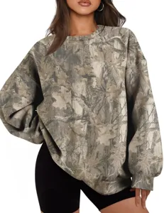 Close-up detail of the oversized crewneck sweatshirt with tree branch camouflage print.