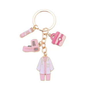 Cute pink medical enamel keychain with doctor coat, thermometer and medical bag charms!