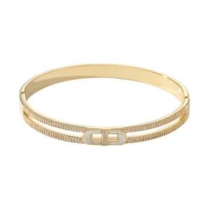 Gold-plated double row pavé cubic zirconia bangle bracelet with mother of pearl clasp.