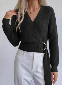 Close-up detail of the black ribbed knit wrap sweater featuring a stylish gold metal ring belt.
