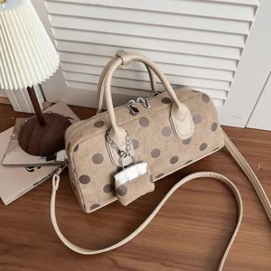 Detailed view of the stylish Korean style polka dot handbag with top handles and chic small pouch.