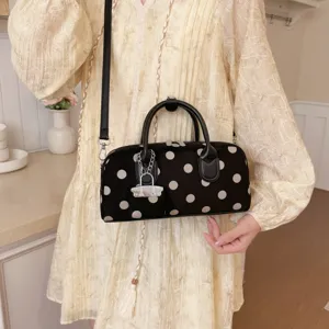 Detailed view of the trendy Korean style polka dot handbag, versatile shoulder and crossbody bag.
