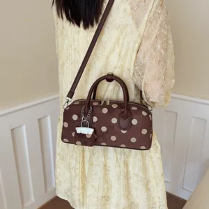 Brown polka dot cylindrical shoulder bag, stylish casual crossbody bag for women daily commute.