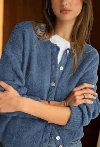 Close-up detail of women casual solid color long sleeve button knit cardigan sweater top.